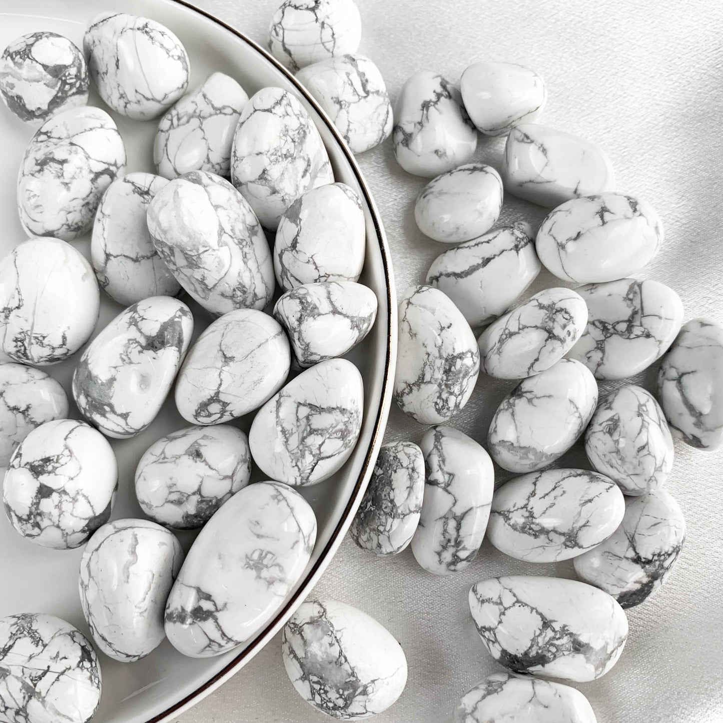 Assorted Howlite pocket gems in a bowl, known for their calming energy and emotional balance.