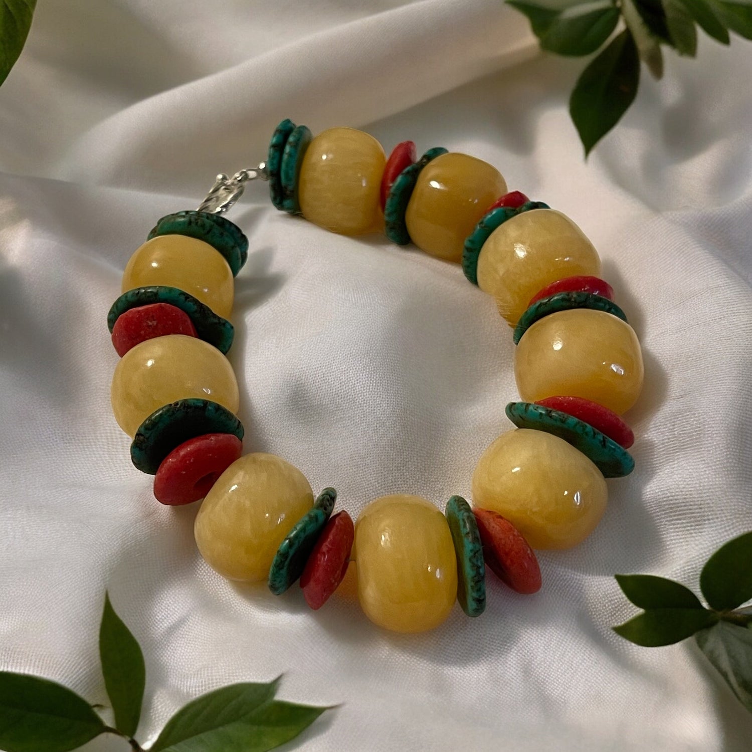 Vibrant healing stone energy bracelet with yellow and red beads, designed for style and energy balance.