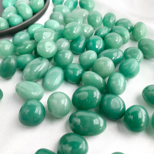 Variety of smooth green aventurine pocket gems, known for attracting luck and prosperity.