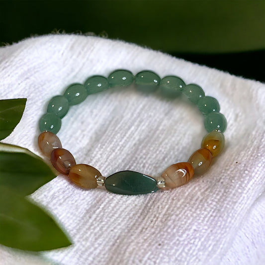 Handcrafted jade and carnelian bracelet Soul Sync, showcasing smooth oval beads in green and golden hues.